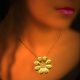 22k gold chain necklace with a rosette shaped pendant, decorated with filigree and speckles