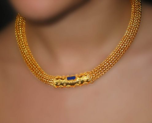 18k gold chain necklace with speckled decoration and a semi-precious stone as the central attraction