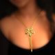 22k gold chain necklace, the element in the shape of lily is hanging in the middle, decorated with enamel