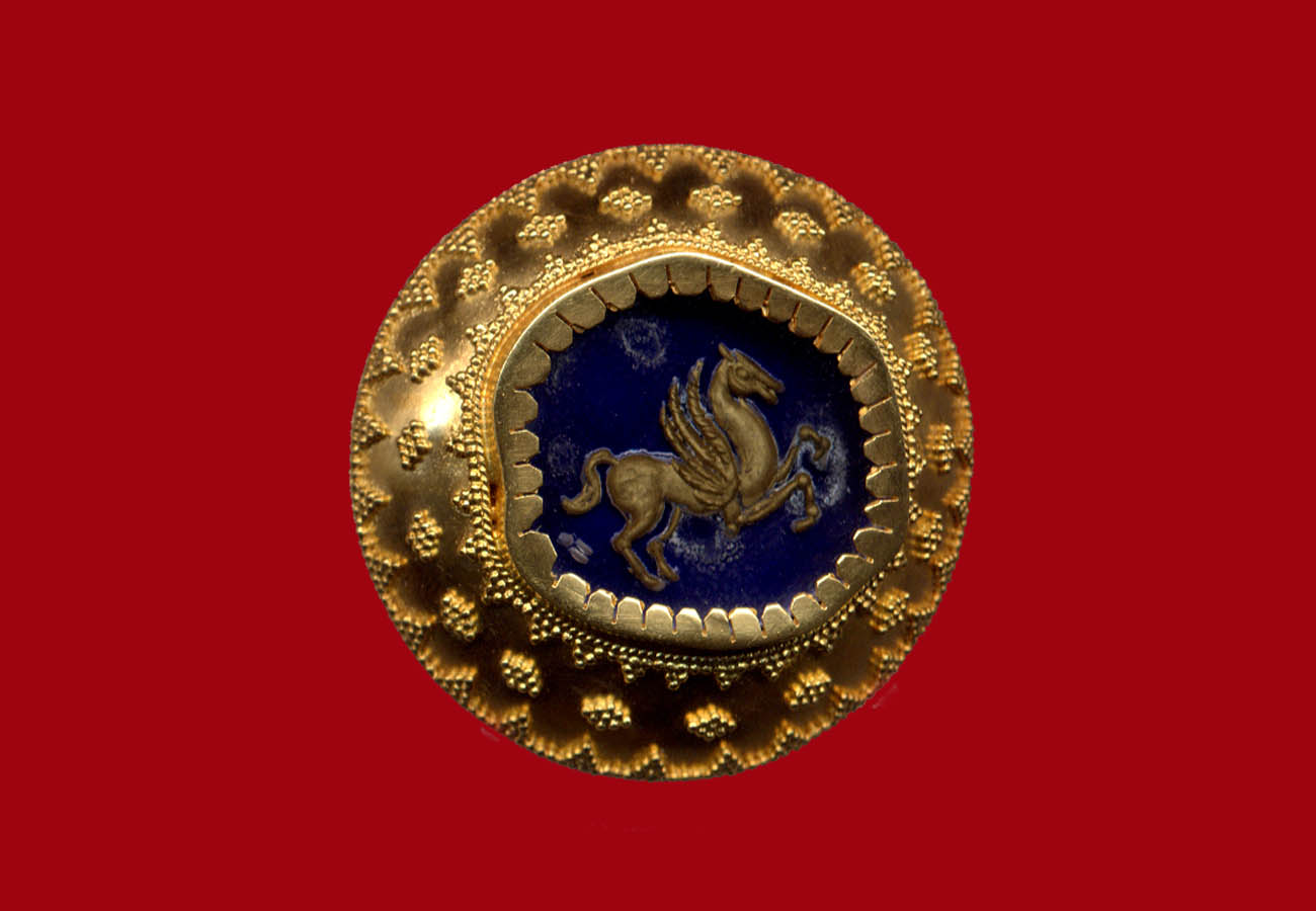 22k yellow gold brooch decorated with the technique of granulation, semi-precious stone and central theme the engraved presentation of Pegasus