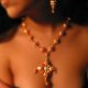 Silver gold platted wired earrings and necklace, from the necklace is hanging a cross, T